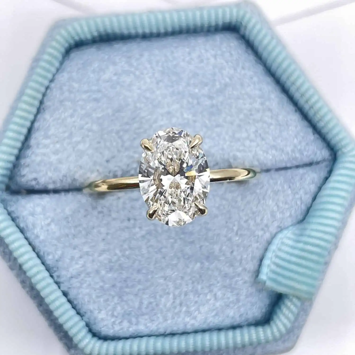 Oval Cut Diamond Solitaire Engagement Ring on a blue box