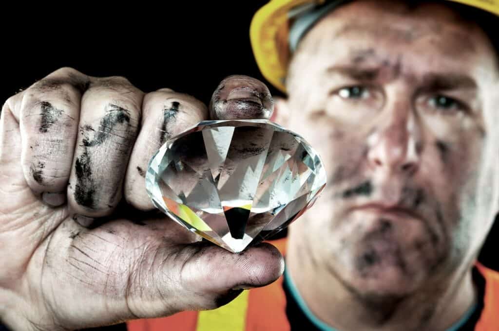 Ariel Jewelry | Lab Grown Diamonds - What Are They? mine man pinching a big diamond to present