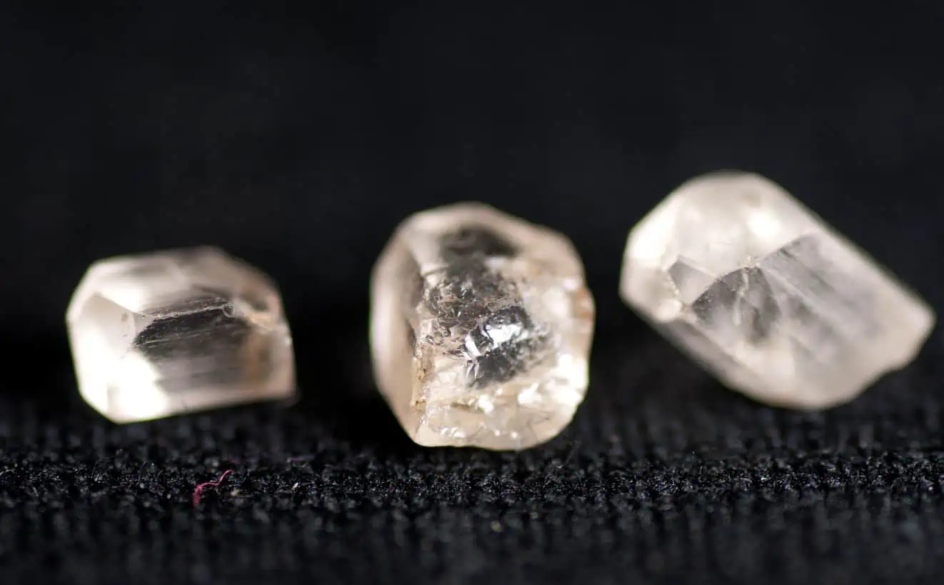3 Lab grown diamonds shown on a black surface
